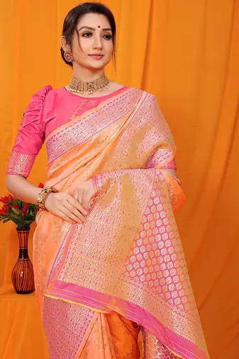 Peach banarasi silk blend saree with pink zari woven border