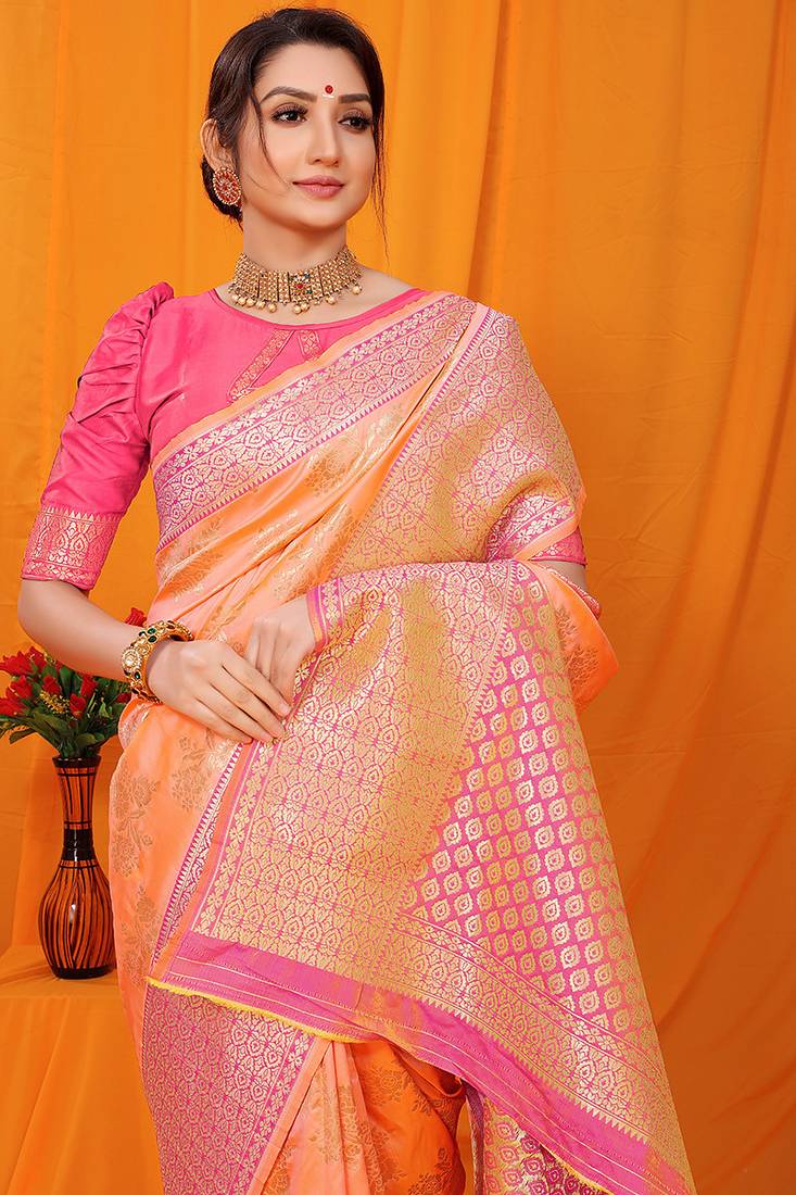 Peach banarasi silk blend saree with pink zari woven border