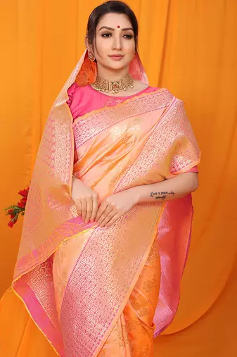 Peach banarasi silk blend saree with pink zari woven border