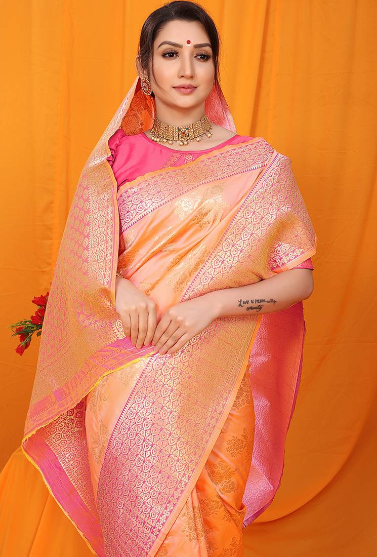 Peach banarasi silk blend saree with pink zari woven border