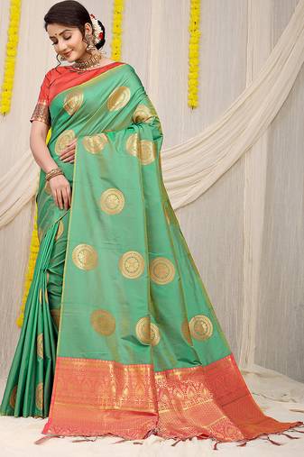 Sea green silk blend saree with pink zari border and circular motifs