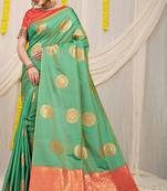 Sea green silk blend saree with pink zari border and circular motifs