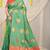 Sea green silk blend saree with pink zari border and circular motifs
