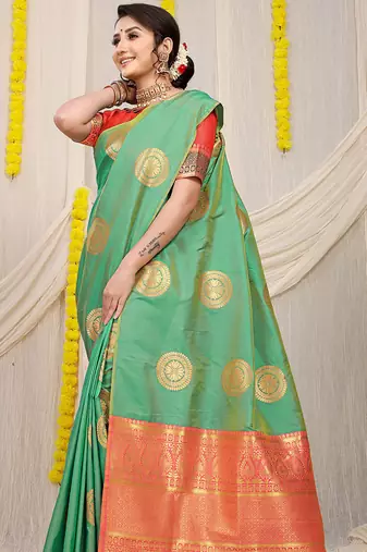 Sea green silk blend saree with pink zari border and circular motifs