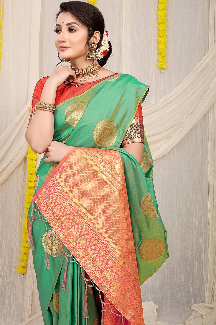 Sea green silk blend saree with pink zari border and circular motifs