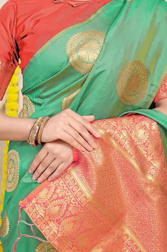 Sea green silk blend saree with pink zari border and circular motifs