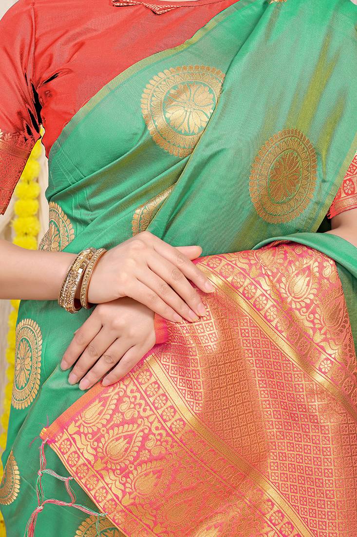 Sea green silk blend saree with pink zari border and circular motifs