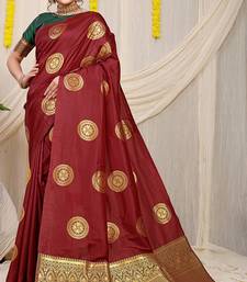 Maroon silk blend saree with dark green zari border and circular motifs
