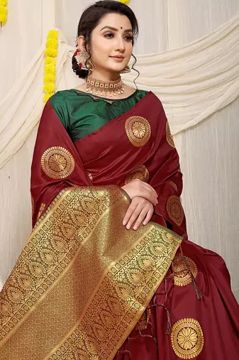 Maroon silk blend saree with dark green zari border and circular motifs