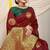 Maroon silk blend saree with dark green zari border and circular motifs