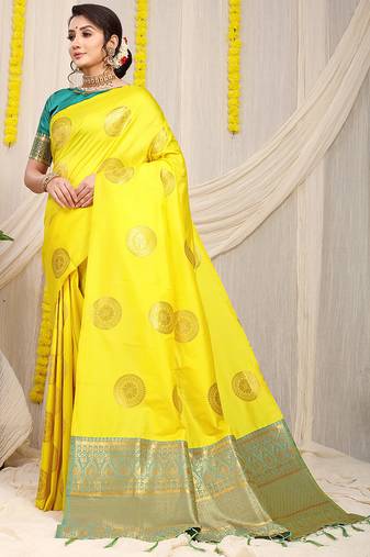 Yellow silk blend saree with teal zari border and circular motifs