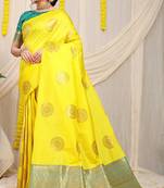 Yellow silk blend saree with teal zari border and circular motifs