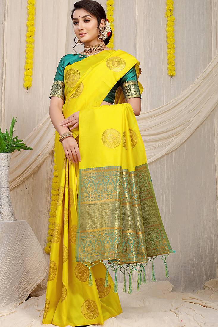 Yellow silk blend saree with teal zari border and circular motifs