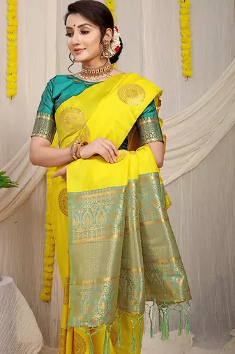 Yellow silk blend saree with teal zari border and circular motifs