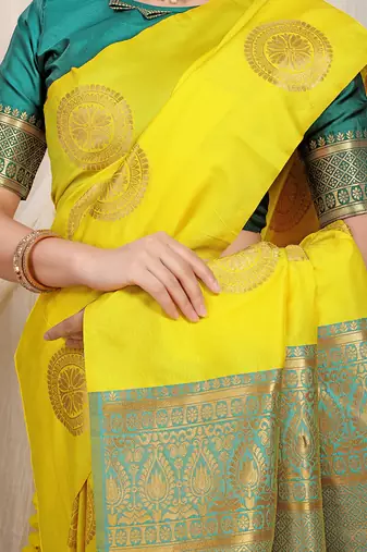 Yellow silk blend saree with teal zari border and circular motifs
