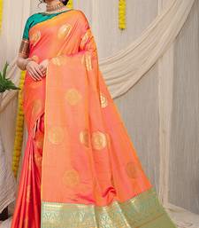 Peach silk blend saree with turquoise zari border and circular motifs
