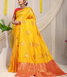 Mustard yellow silk blend saree with red zari border and circular motifs