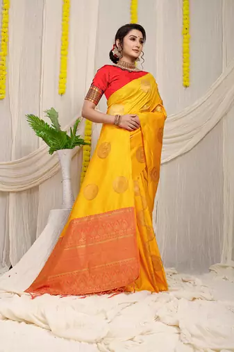Mustard yellow silk blend saree with red zari border and circular motifs