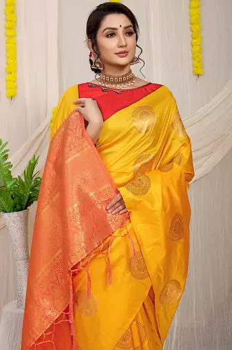 Mustard yellow silk blend saree with red zari border and circular motifs