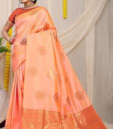 Light peach silk blend saree with rust orange zari border and circular motifs