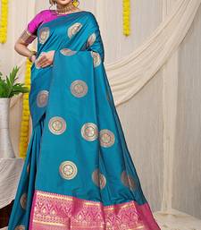 Teal blue silk blend saree with magenta pink zari border and circular motifs