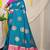 Teal blue silk blend saree with magenta pink zari border and circular motifs