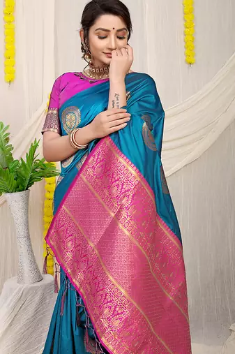 Teal blue silk blend saree with magenta pink zari border and circular motifs