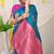 Teal blue silk blend saree with magenta pink zari border and circular motifs