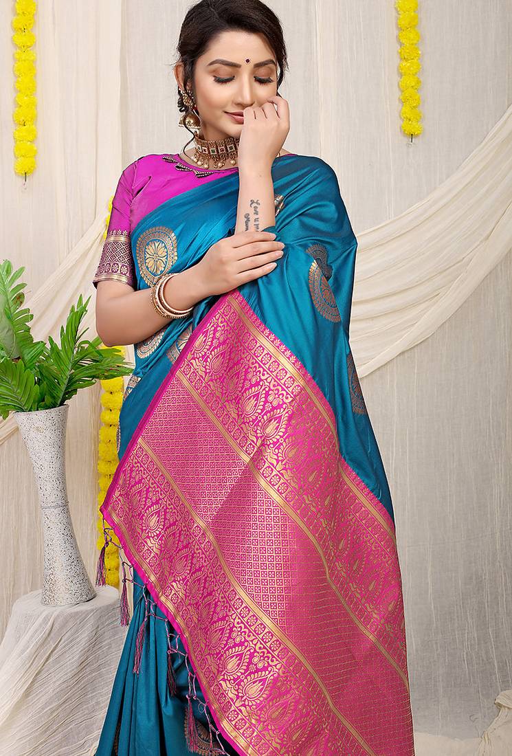 Teal blue silk blend saree with magenta pink zari border and circular motifs