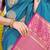 Teal blue silk blend saree with magenta pink zari border and circular motifs