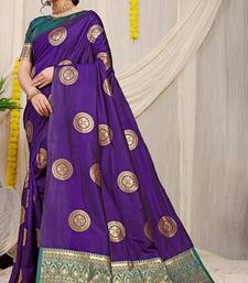 Purple silk blend saree with teal zari border and circular motifs