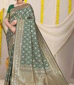 Dark green woven banarasi silk blend saree with blouse piece