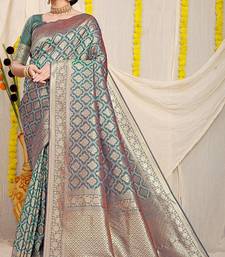 Teal green woven banarasi silk blend saree with blouse piece