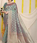 Teal green woven banarasi silk blend saree with blouse piece