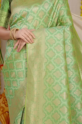 Light green woven banarasi silk blend saree with blouse piece