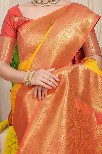 Yellow silk blend kanjivaram saree with peach zari border