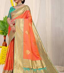 Coral orange silk blend kanjivaram saree with turquoise zari border