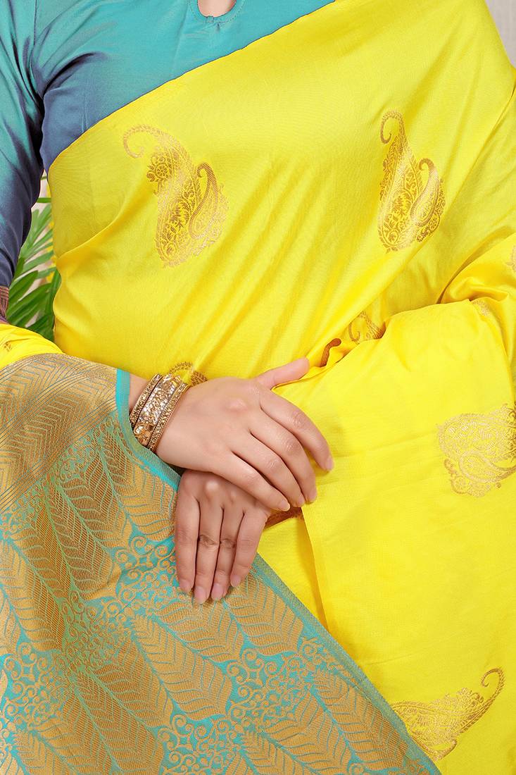 Yellow silk blend saree with rich zari paisley weaving & sea green contrast border
