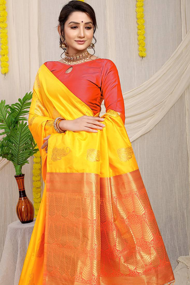 Yellow silk blend saree with rich zari paisley weaving & red contrast border