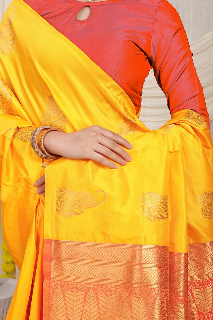 Yellow silk blend saree with rich zari paisley weaving & red contrast border