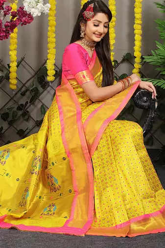 Yellow paithani silk blend saree with  rani pink border and peacock pallu