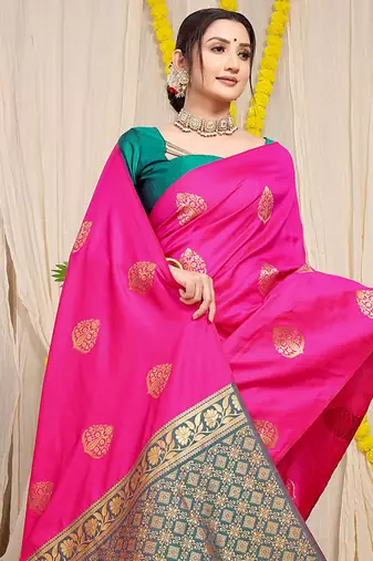 Rani pink banarasi silk blend saree with  zari butta & teal woven border