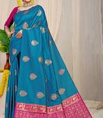 Teal blue banarasi silk blend saree with  zari butta & magenta pink woven border