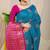 Teal blue banarasi silk blend saree with  zari butta & magenta pink woven border