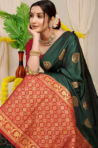 Bottle green banarasi silk blend saree with  zari butta & maroon woven border