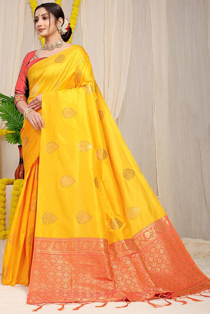 Mustard yellow banarasi silk blend saree with  zari butta & coral orange woven border