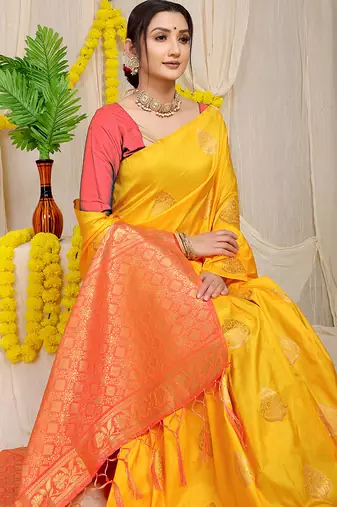 Mustard yellow banarasi silk blend saree with  zari butta & coral orange woven border