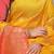 Mustard yellow banarasi silk blend saree with  zari butta & coral orange woven border