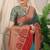 Teal banarasi silk blend saree with red zari border & brocade blouse