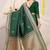 Bottle green banarasi silk blend saree with zari border & woven buti design